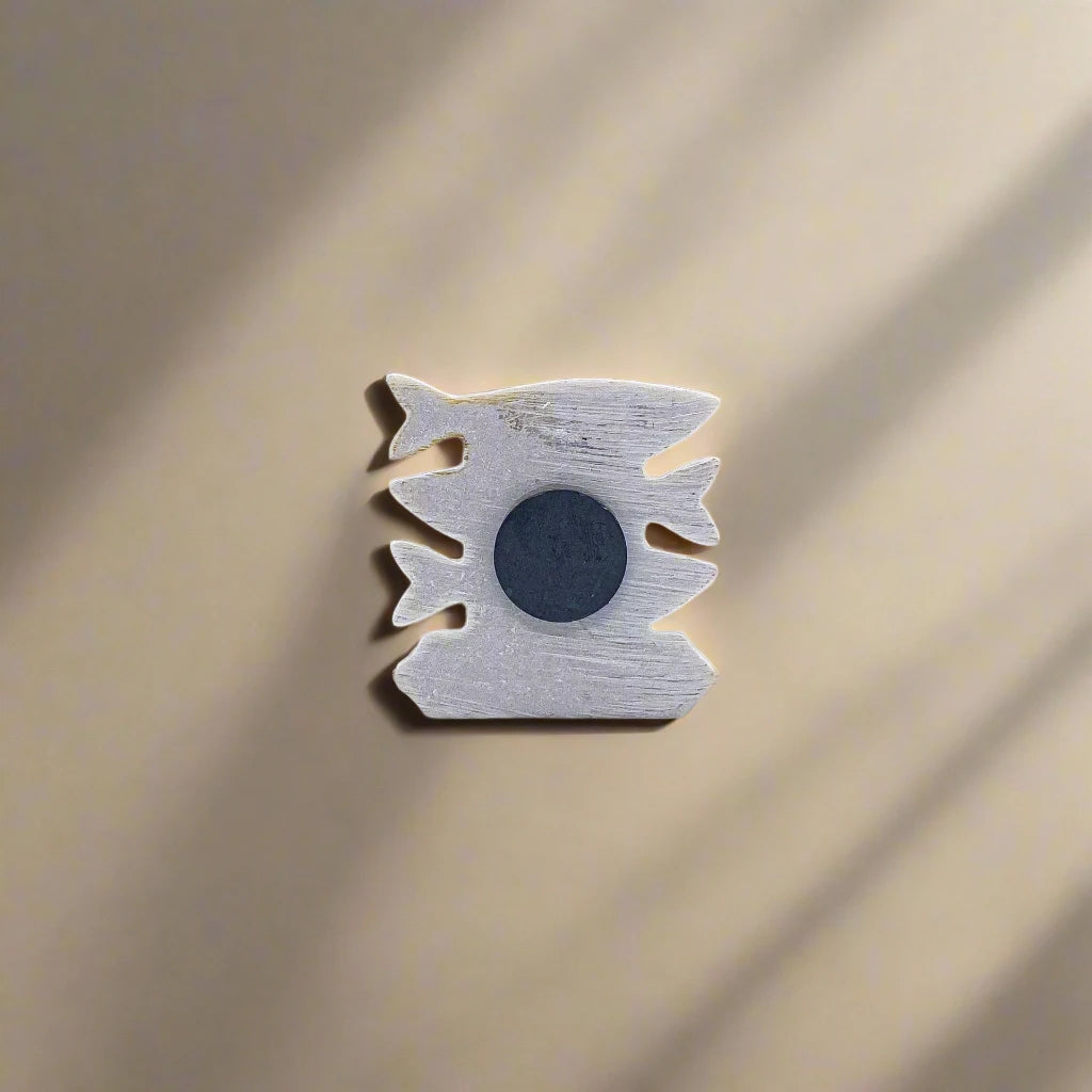 A ceramic artwork showcasing three brightly colored fish with intricate designs in blue, red, and yellow. Below the fish, the word "AÇORES" is displayed in bold, vibrant letters. This striking Portugal souvenir magnet is set against a plain white background.