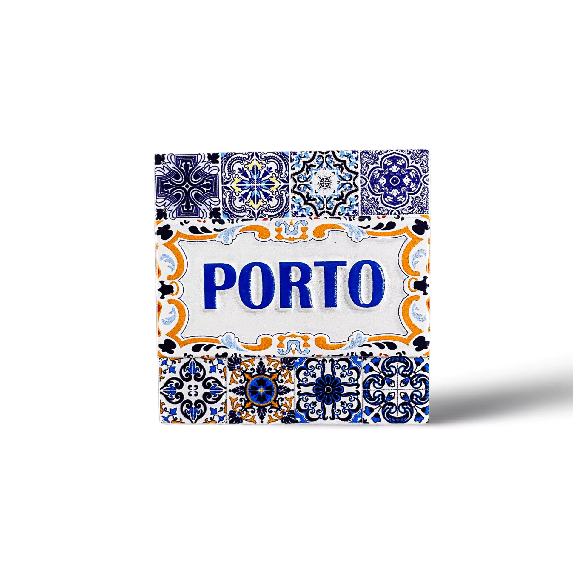 A decorative tile art piece with the word "PORTO" in blue, surrounded by various intricate designs in blue, white, and yellow. This charming magnet features floral and geometric patterns on a traditional Portuguese azulejo style background, making it a perfect souvenir from Porto.