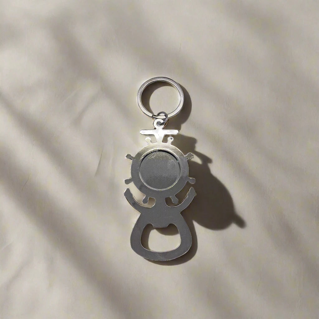 A ship's wheel and anchor-shaped silver keychain bottle opener, featuring a blue and yellow mosaic design with "Lisboa" prominently displayed in the center. This charming souvenir makes a great gift for any Lisbon lover.