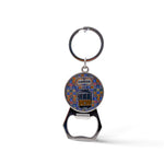 A keychain with a bottle opener attached. The round element shows a colorful illustration of a Lisbon tram with the word "Lisboa" at the top. This charming souvenir features a background pattern reminiscent of traditional Portuguese tiles.