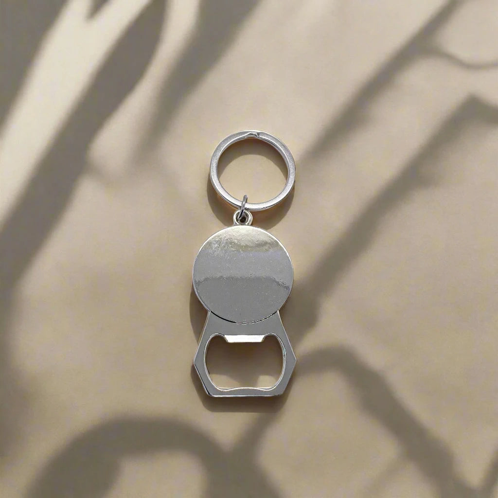 A keychain combined with a bottle opener, highlighted by a circular element depicting a colorful Lisbon tram and the word "Lisboa" above it. The backdrop is adorned with a design reminiscent of classic Portuguese tiles, adding to the charm of this souvenir.