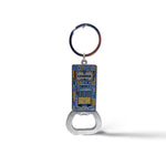 A metal keychain featuring a bottle opener at the bottom and a rectangular enamel tile at the top with a depiction of a Lisbon tram. The word "Lisboa" is written above the tram, surrounded by a decorative blue and yellow border, capturing the charm of Portugal.