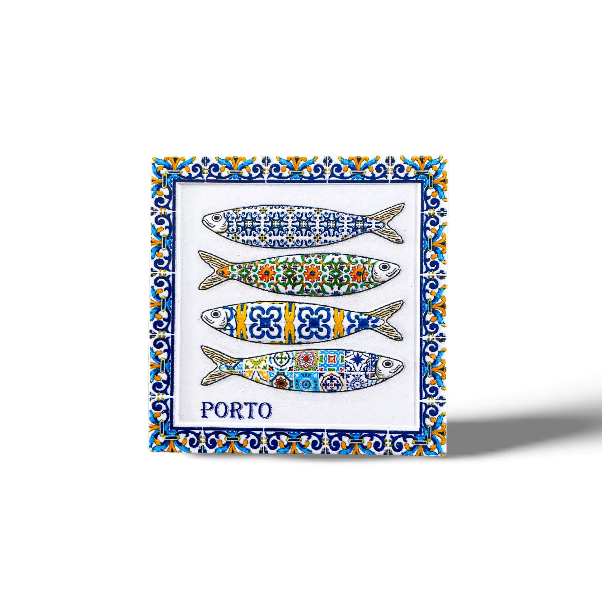A decorative tile magnet featuring four colorful sardines with intricate patterns in shades of blue, green, yellow, and red. Each sardine has a unique design. The souvenir tile has a blue and yellow floral border and the word "PORTO" written at the bottom.
