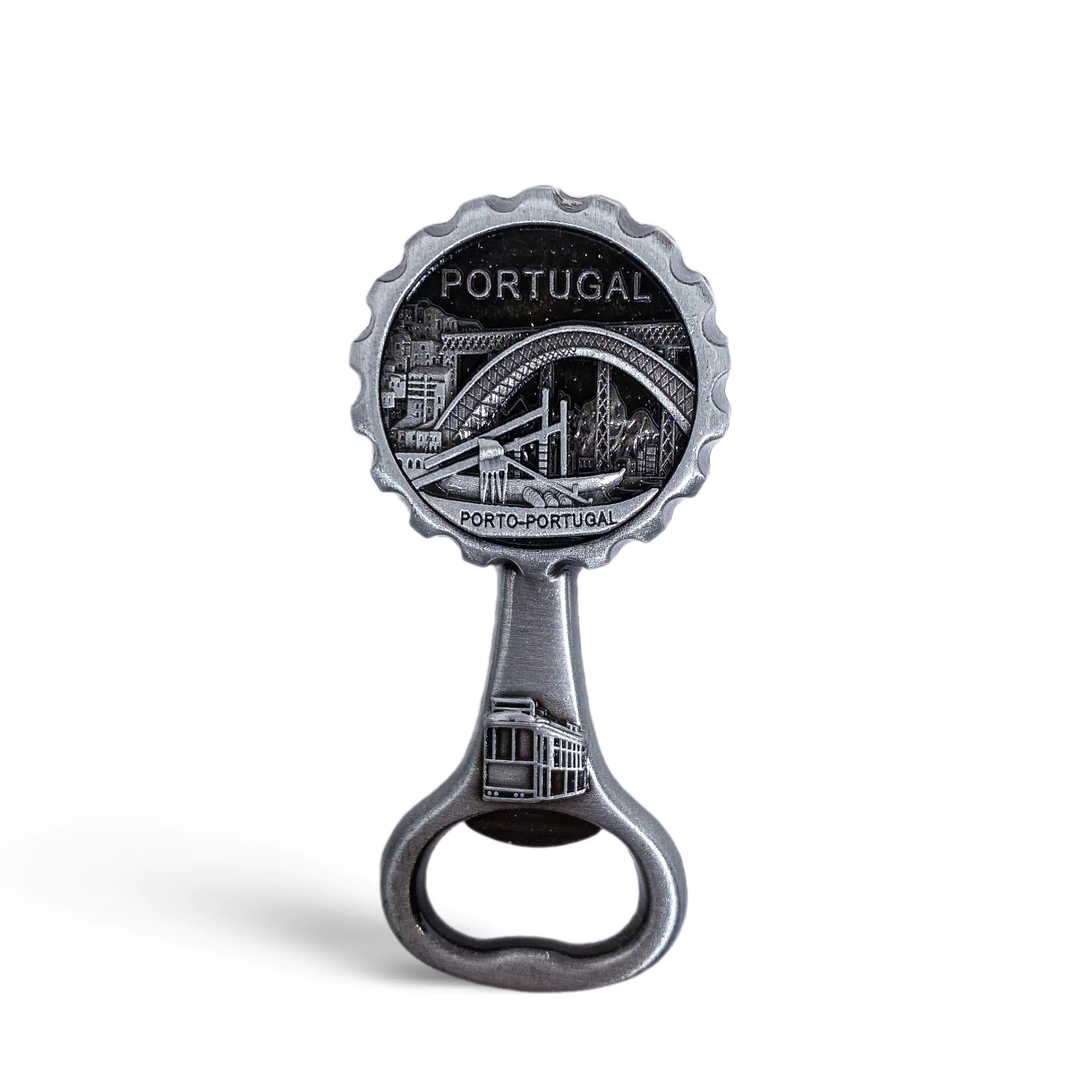 A silver bottle opener souvenir featuring an engraved image of a bridge and cityscape labeled "PORTUGAL" with "PORTO-PORTUGAL" written underneath. The handle also has an engraving of a tram. The background is a plain white.