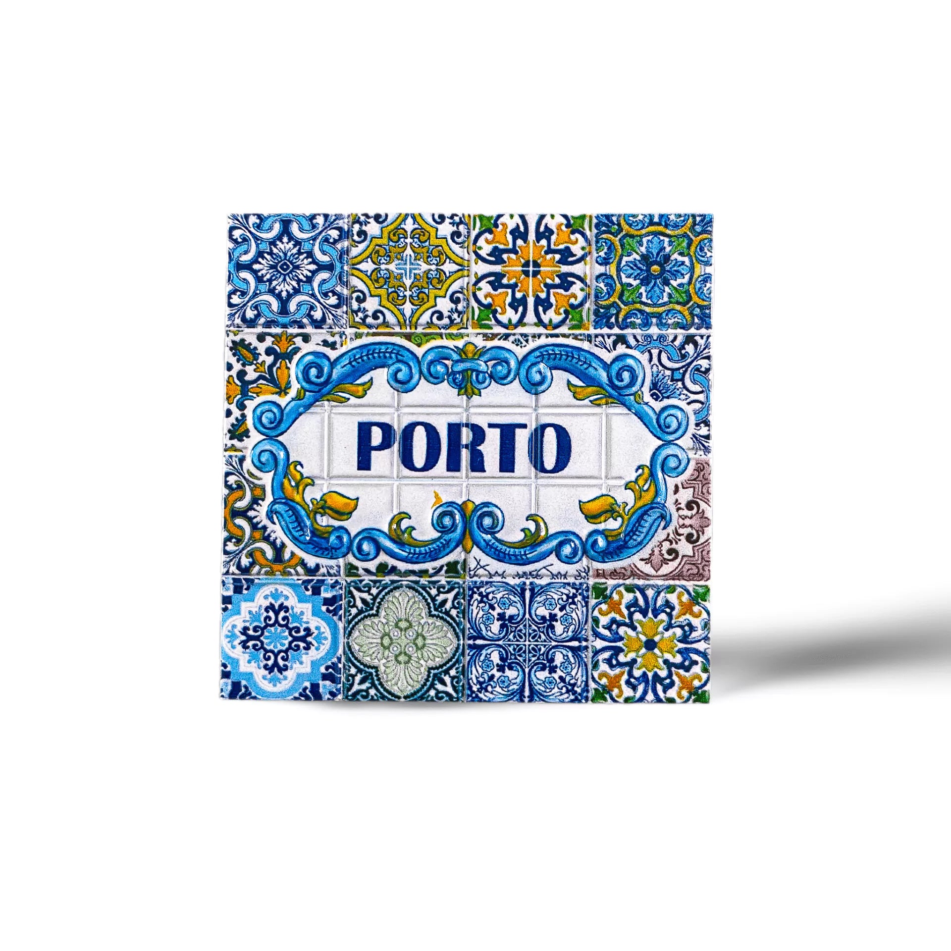 This colorful ceramic tile magnet features intricate designs in blue, yellow, green, and white. The center panel displays the word "PORTO" in bold blue letters, surrounded by ornate patterns reminiscent of traditional Portuguese azulejos. It's a perfect souvenir from Portugal.