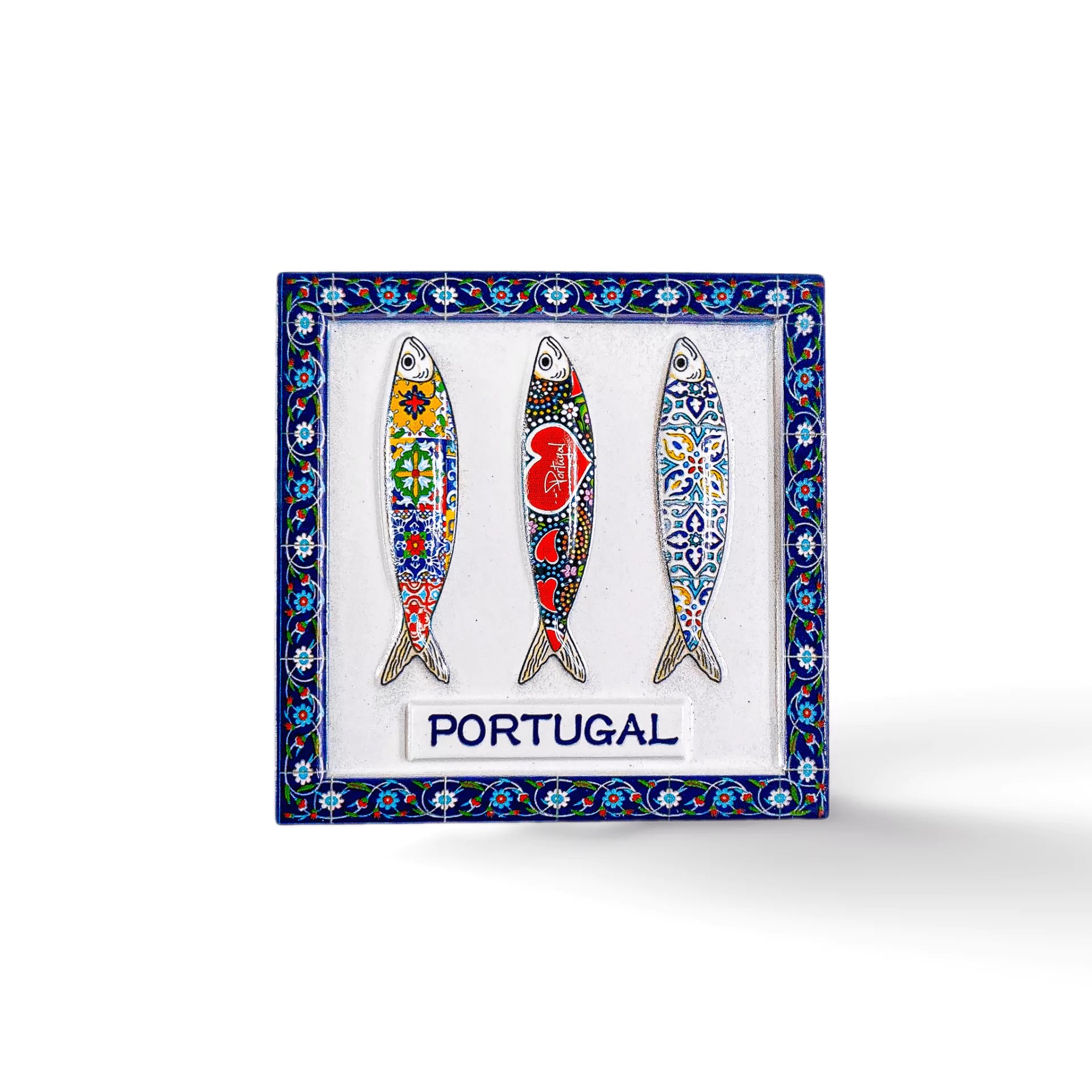 A decorative magnet featuring three illustrated sardines adorned with intricate, colorful patterns inspired by traditional tile design. Each sardine has a unique flair and is framed by a blue, white, and green patterned border. The word "PORTUGAL" is elegantly written at the bottom, making it a perfect souvenir.