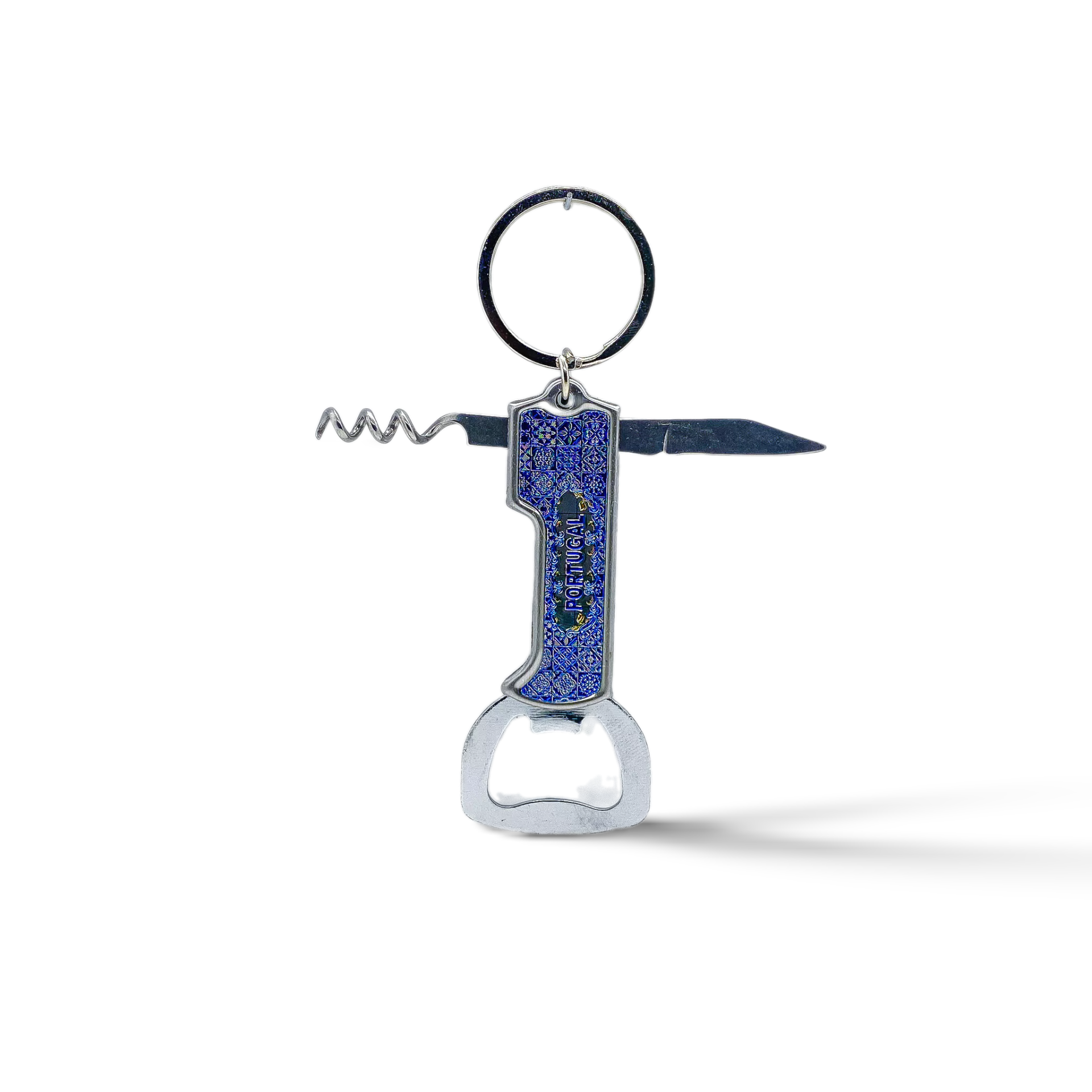 A blue and silver souvenir keychain featuring a bottle opener, corkscrew, and small knife, all in one compact design. The keychain is adorned with an intricate blue pattern and is connected to a sturdy metal ring. Set against a plain white background, this multifunctional piece makes a perfect keepsake.