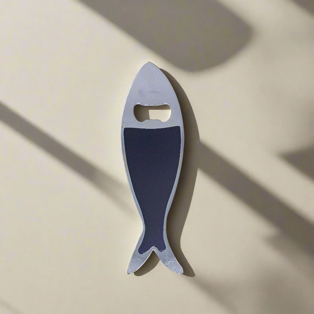 This metal bottle opener, designed as a sardine, is embellished with intricate, colorful details, including a famous Lisbon landmark and "Lisboa" text. The opener hole is positioned at the fish's eye, adding a unique touch to this Portugal keepsake.