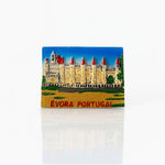 A 3D relief fridge magnet featuring the historic cathedral in Évora, Portugal, with red turrets and a blue sky background, labeled Évora Portugal.