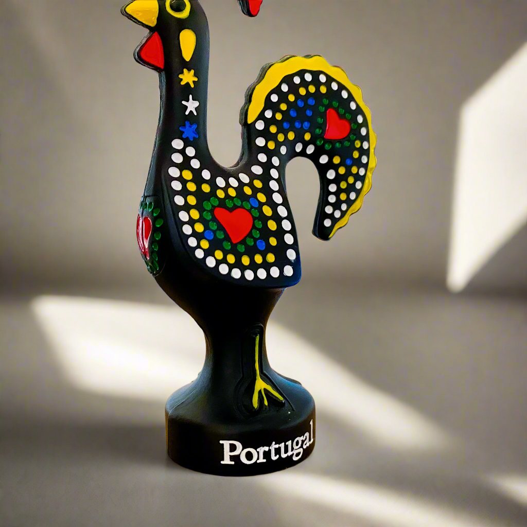 A black rooster figurine with colorful red and yellow feathers, a souvenir symbolizing the Galo de Barcelos from Portugal.