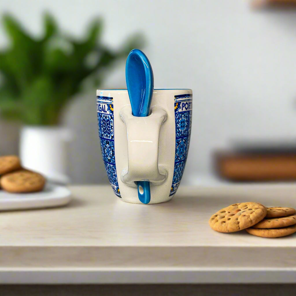 Mug with a spoon holder and blue pattern on a neutral background