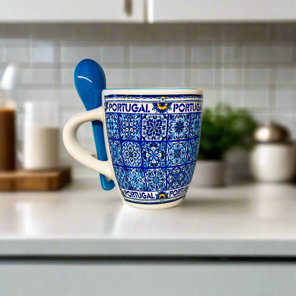 Blue and white patterned mug with "Portugal" text and a blue spoon on a beige surface.