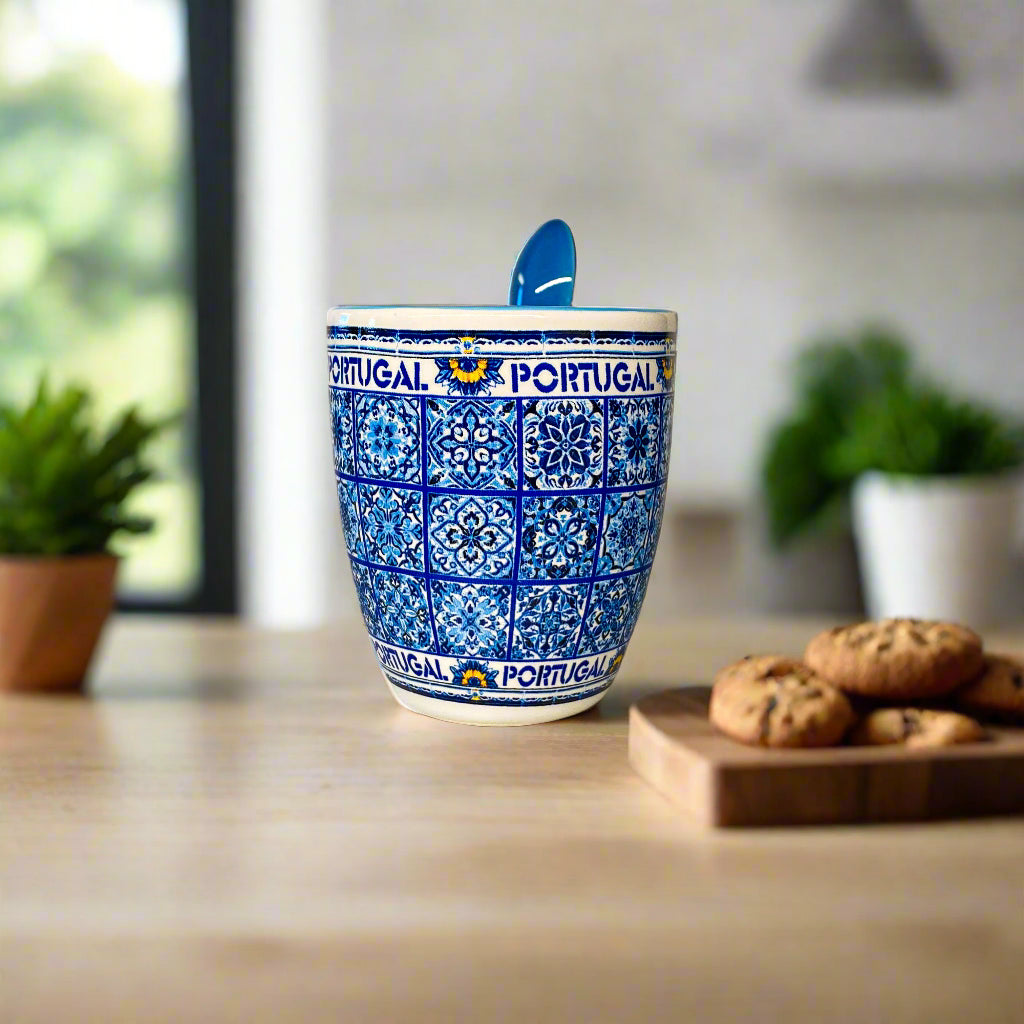Ceramic mug with blue and white pattern and 'Portugal' text on a beige surface.
