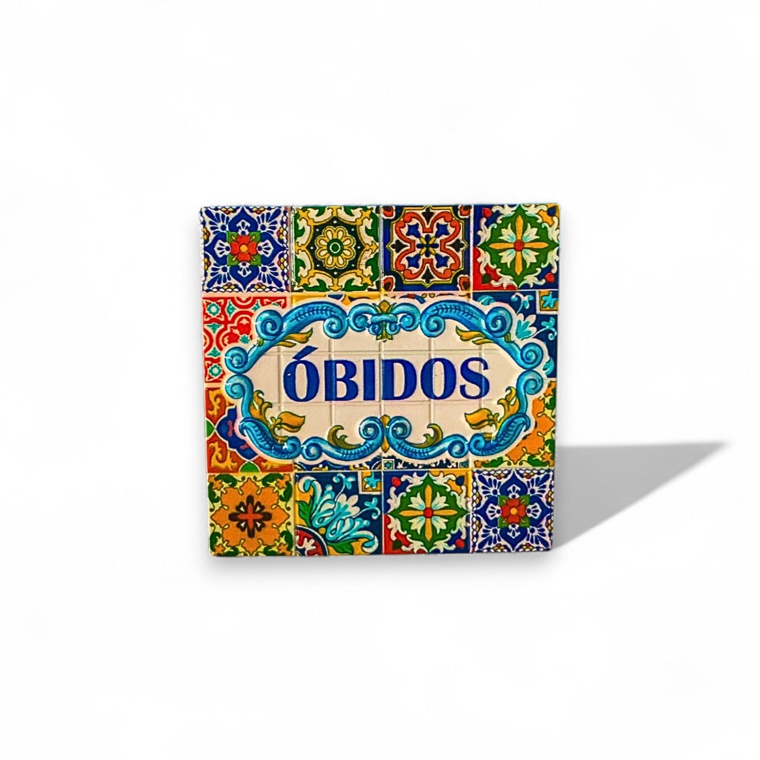 A colorful Óbidos fridge magnet featuring traditional Portuguese tile patterns and the name Óbidos in bold lettering.