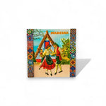 A colorful fridge magnet featuring an illustration of a traditional house and a couple in folk dance attire, with a 'Madeira' text and decorative tile frame.