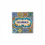 A colorful square-shaped fridge magnet with traditional Portuguese tile patterns and the word 'Alcobaça' in the center.