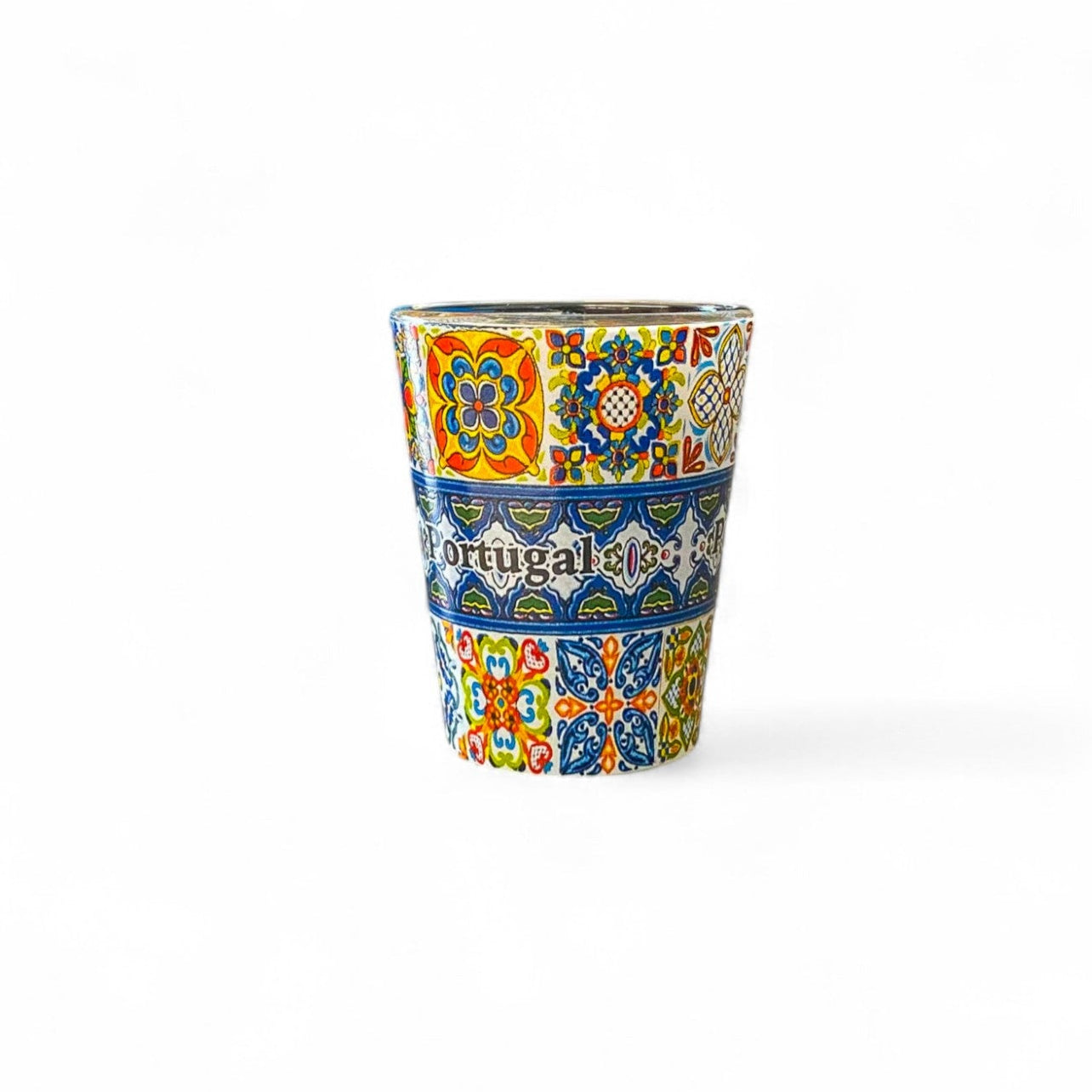 A shot glass with multicolored traditional Azulejo tile patterns from Portugal.