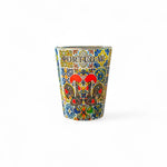 A colorful shot glass souvenir featuring the Galo de Barcelos and traditional Azulejo patterns, with the word 'PORTUGAL' written across the top.