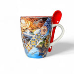 Algarve souvenir ceramic mug decorated with scenic illustrations of Algarve's coastline, azulejo tile bands, and a red ceramic spoon placed in the handle.