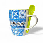 A blue and white ceramic mug with a striped tile design and the word 'Portugal' written on it, accompanied by a matching blue spoon, displayed against a white background.