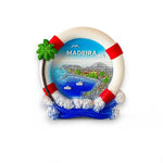 A fridge magnet designed as a lifeguard ring with a palm tree and ocean waves, featuring the Madeira archipelago and miniature dolphins in the background.