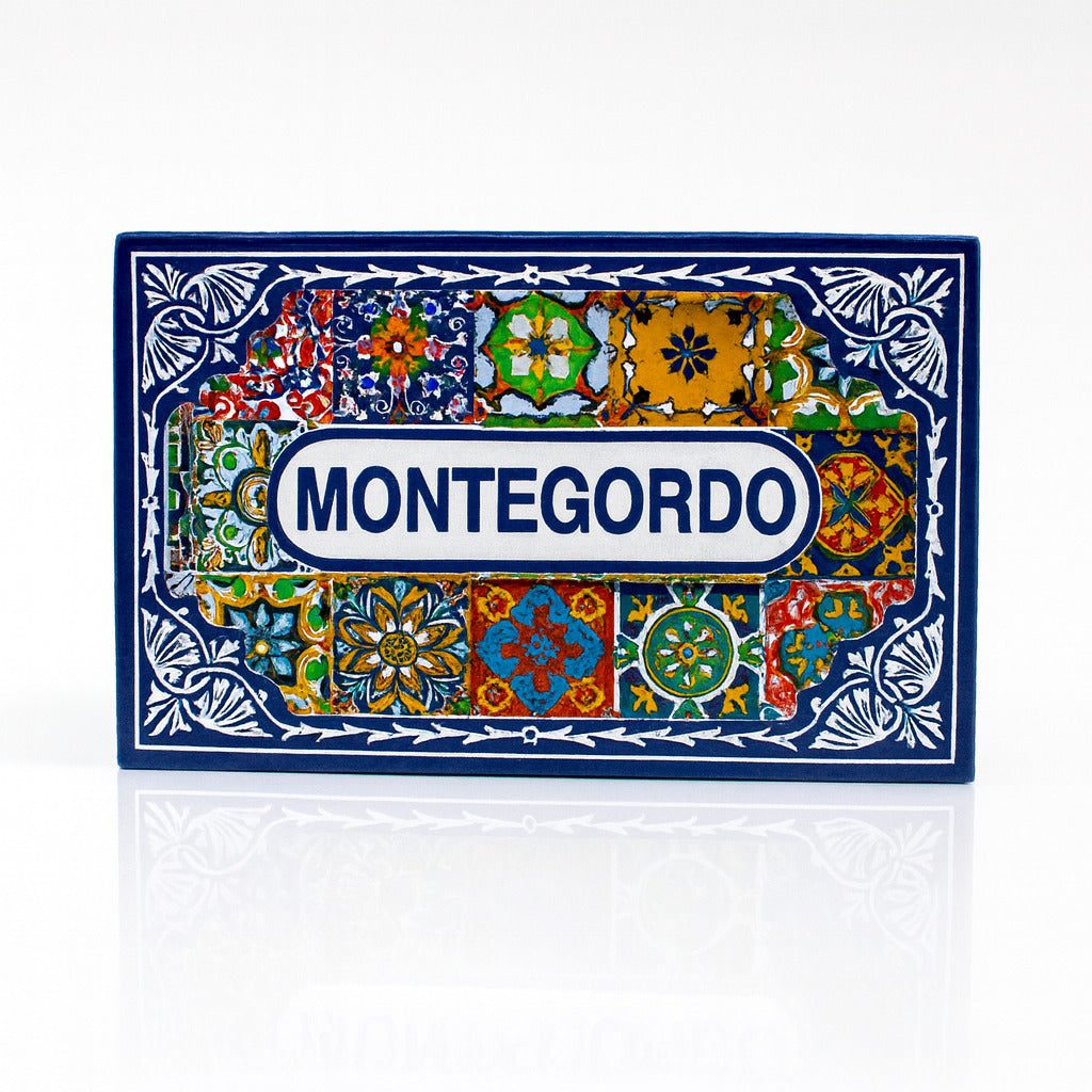 Rectangular magnet with the word “Montegordo” centered in blue on a white label, surrounded by colorful Portuguese azulejo tile patterns and a dark blue ornamental border