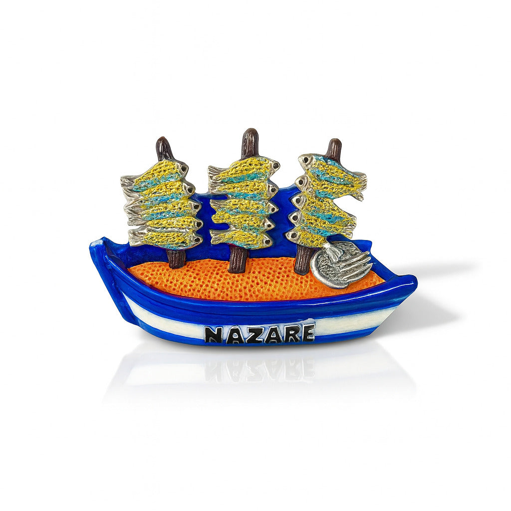 A colorful fridge magnet featuring a 3D relief of a traditional fishing boat with drying fish racks, resembling those seen at Nazaré beach in Portugal.