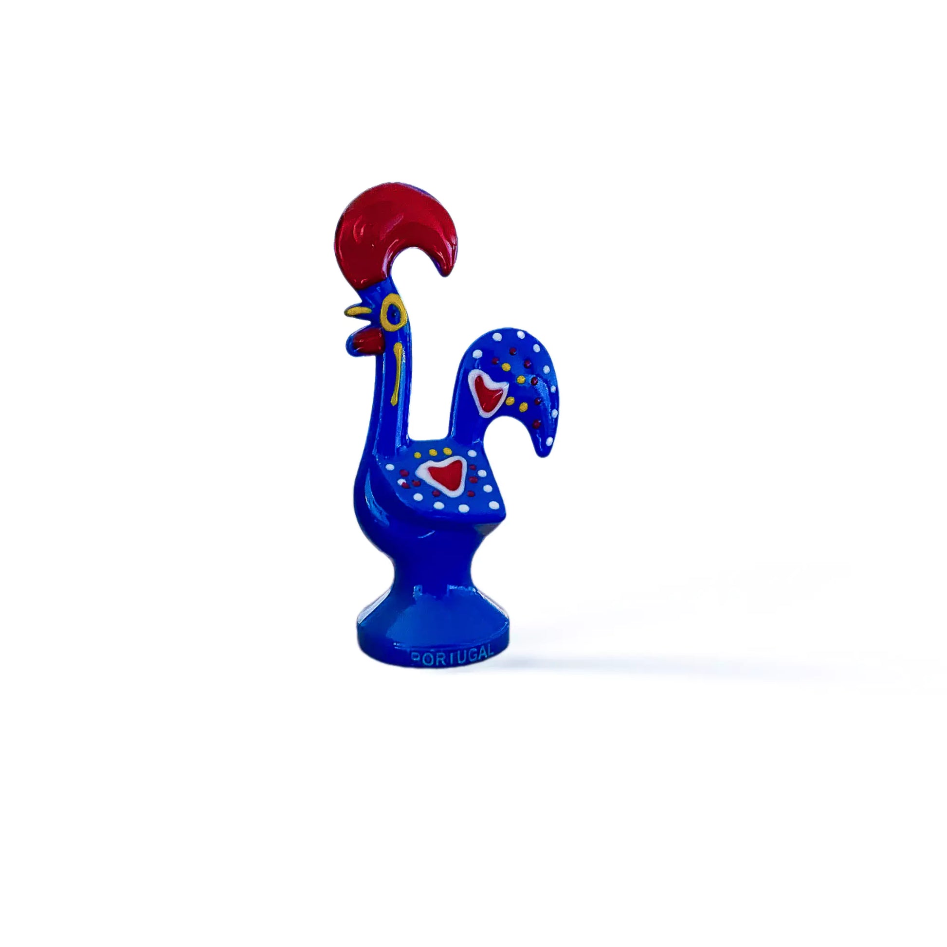 A blue and red rooster figurine, a souvenir representing the Galo de Barcelos from Portugal.