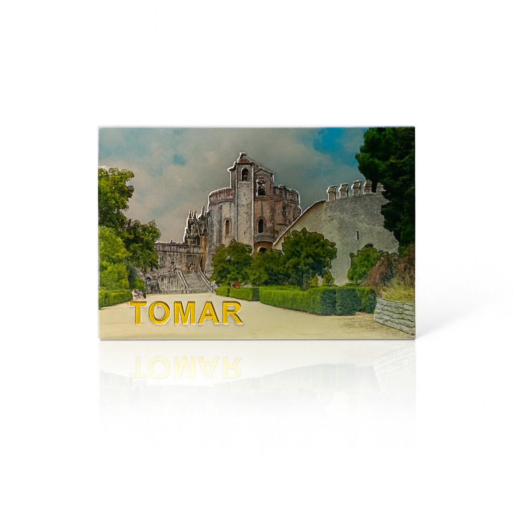 Magnet showing a realistic image of the Convento de Cristo in Tomar, Portugal, with garden paths and medieval stone walls under a blue sky