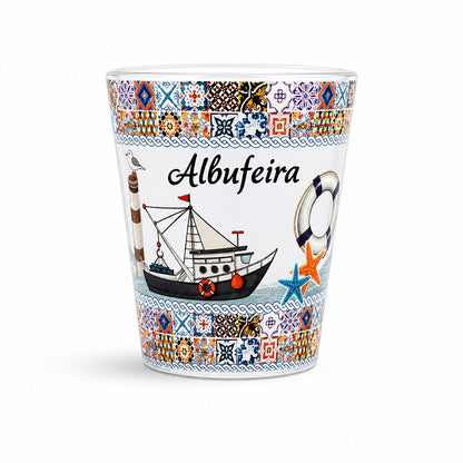 Studio image of Albufeira souvenir shot glass decorated with colorful Portuguese azulejo tiles, fishing boat illustrations, and Algarve coastal symbols