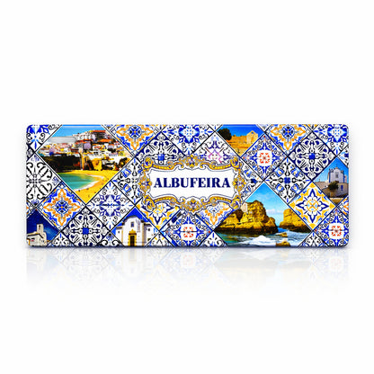 Albufeira metal souvenir sign isolated on white background featuring beaches, cliffs and traditional azulejos patterns