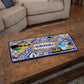 Albufeira metal souvenir sign placed on a wooden table showing beach scenery, cliffs and classic Portuguese tile design