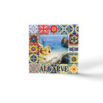 A square picture frame decorated with colorful, intricate tile patterns surrounds a photo of a coastal beach scene with cliffs and blue water. The word "Algarve" is written at the bottom. This eye-catching magnet captures the essence of the Algarve coastline beautifully.
