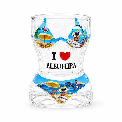 Transparent Albufeira souvenir shot glass with colorful bikini beach design, dolphins, lighthouse illustrations, and I Love Albufeira text on white background.