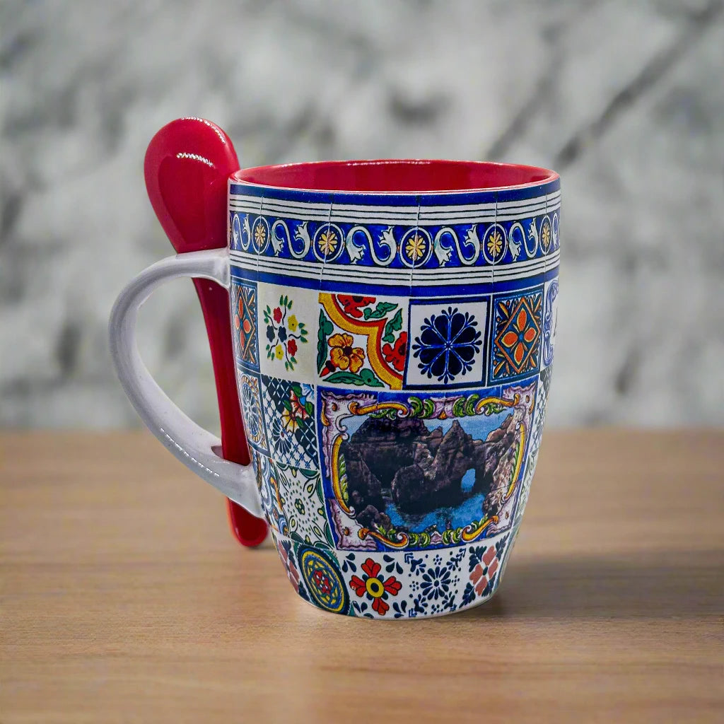 A detailed ceramic mug with a patchwork of intricate, colorful designs featuring various geometric and floral patterns reminiscent of Portugal. The mug has a red interior, a matching red spoon resting in a holder attached to the handle, and evokes memories of a cherished souvenir from the Algarve.