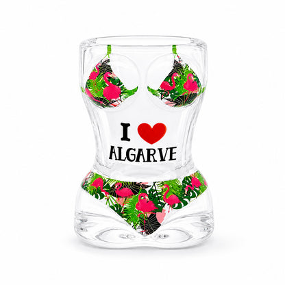 Transparent Algarve souvenir shot glass featuring pink flamingo artwork, tropical leaves, bikini-inspired design, and I Love Algarve text on white background.