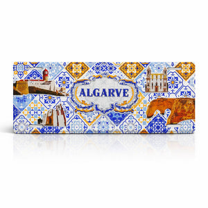Algarve metal souvenir sign isolated on white background featuring coastal landmarks and traditional Portuguese azulejos patterns