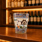 Albufeira Algarve souvenir shot glass featuring nautical wheel, sunglasses, lifebuoy, and colorful Portuguese tile artwork displayed on a wooden counter