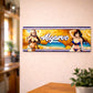 Algarve metal souvenir sign mounted on a wall featuring coastal cliffs, beach scenery and stylized illustrated characters