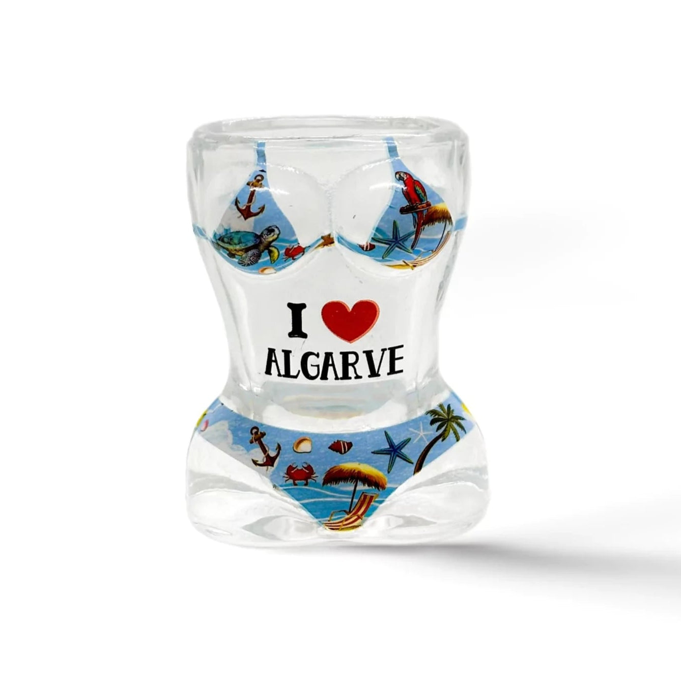 A transparent shot glass with a sculpted torso shape, wearing a bikini illustration. The bikini features beach and ocean scenes. The glass is labeled with "I ♥ Algarve" in black and red text on the front, making it a perfect souvenir from the Algarve region.
