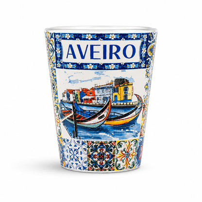 Studio image of Aveiro souvenir shot glass decorated with traditional moliceiro boats, canal houses, and colorful Portuguese azulejo artwork