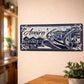Aveiro metal souvenir sign mounted on a wall featuring moliceiro boats, traditional houses and blue azulejos style design