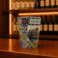 Decorative Aveiro shot glass with canal scenery, moliceiro boats, and vibrant Portuguese tile-inspired patterns on a wooden bar counter