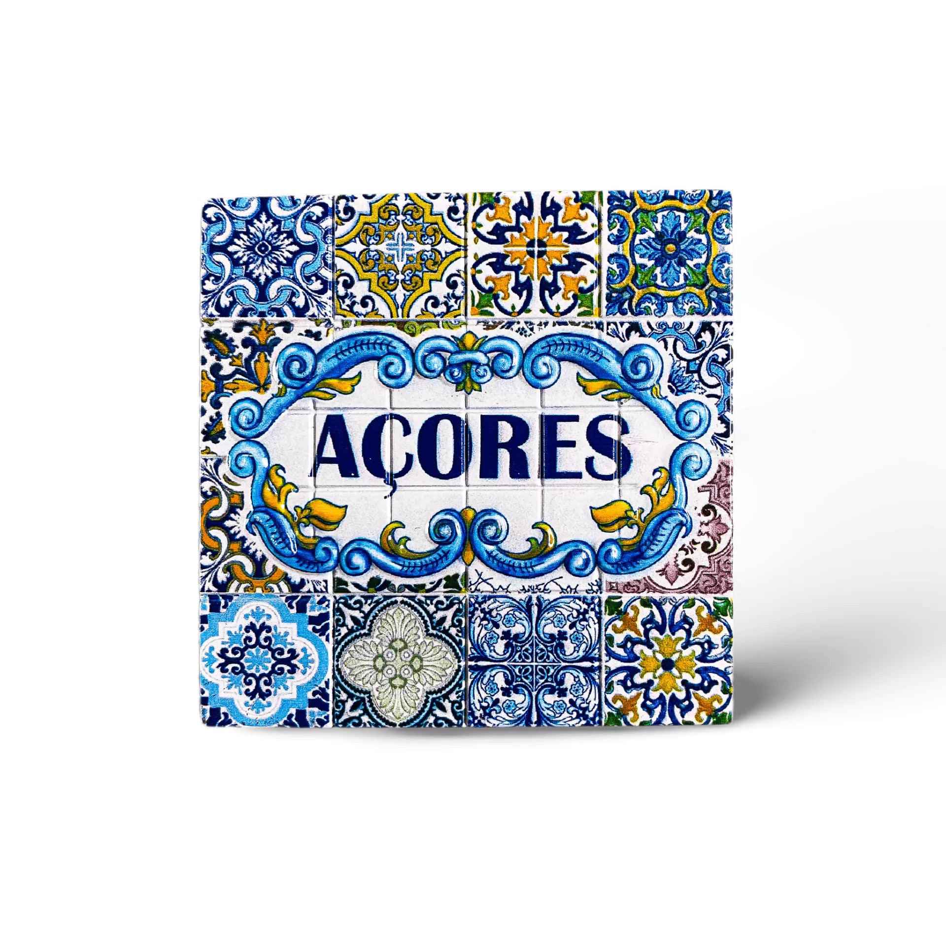 A square decorative tile featuring intricate blue and yellow patterns surrounding the word "ACORES" in bold blue letters. The tile has a traditional, ornate design with various floral and geometric shapes, indicative of Azorean or Portuguese style—a perfect souvenir from the Azores.