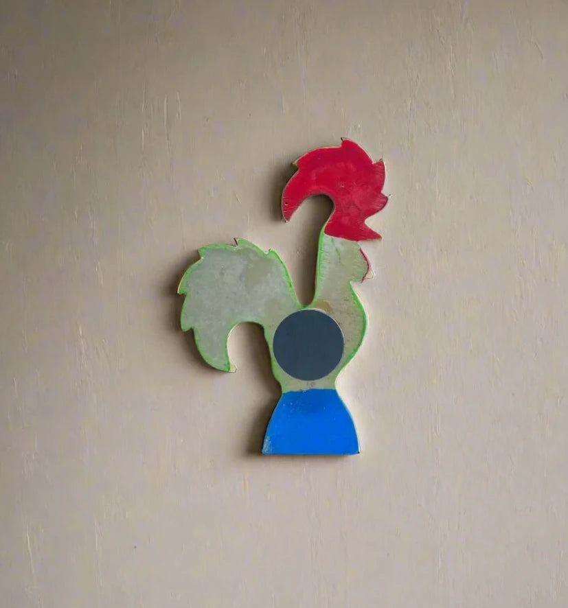 This colorful Portuguese rooster figurine features a green body accented with red hearts and white dots, a red comb and wattles, and sits on a blue base marked "Portugal." Designed as both a decoration and a magnet, it's an ideal keepsake.