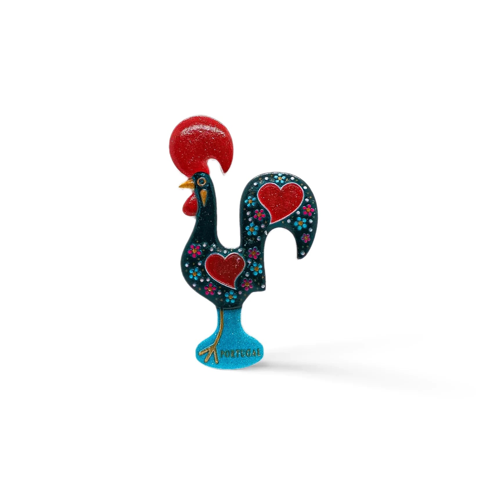 A vibrant Barcelo Rooster figurine, it boasts a black body adorned with red hearts and small white dots. With a red comb, red wattle, and standing on a blue base inscribed with "Portugal," this charming souvenir showcases intricate floral patterns.