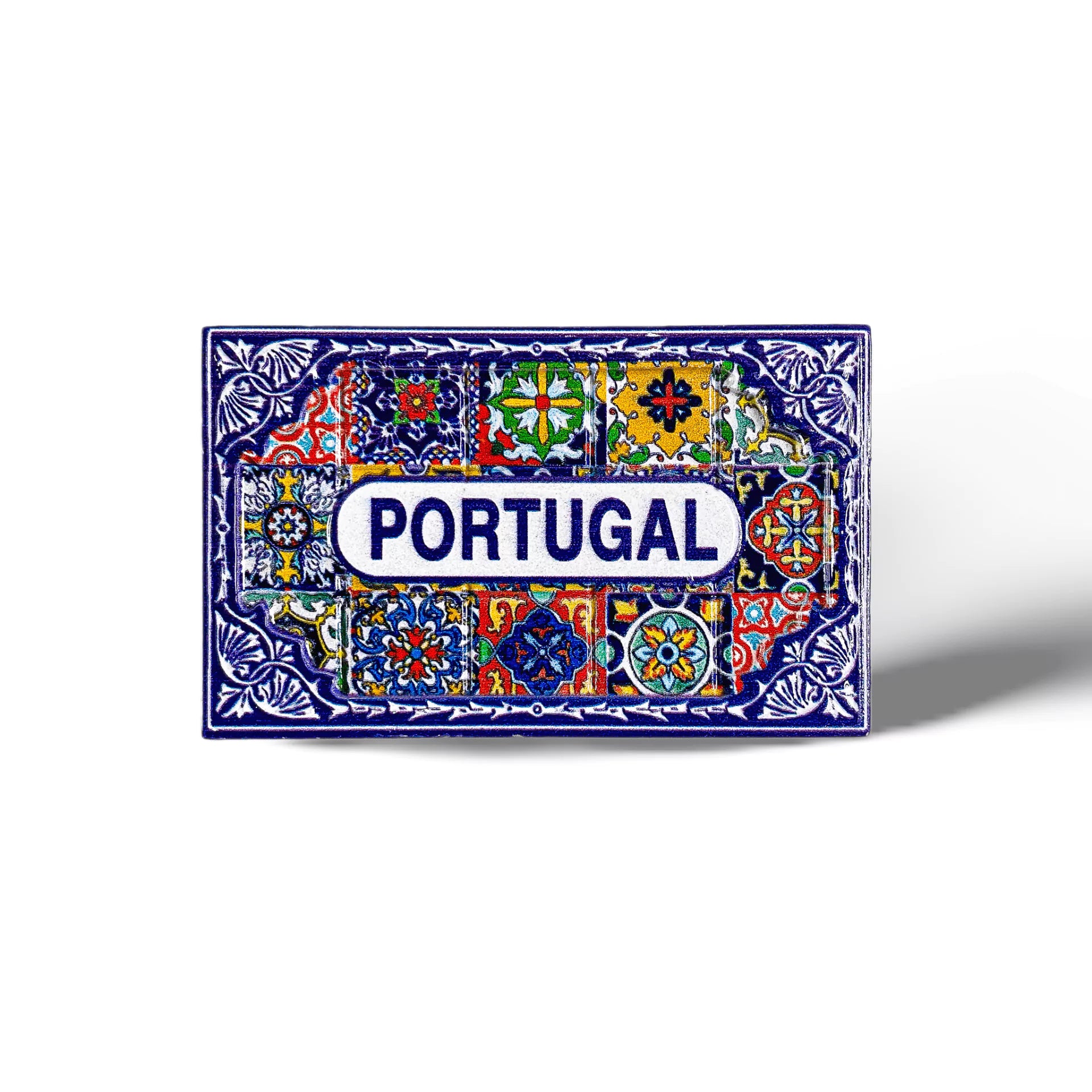 An ornate tile with colorful patterns and detailed designs featuring the word "PORTUGAL" in the center, this souvenir magnet is surrounded by intricate floral and geometric motifs in vibrant shades of red, blue, green, yellow, and white.