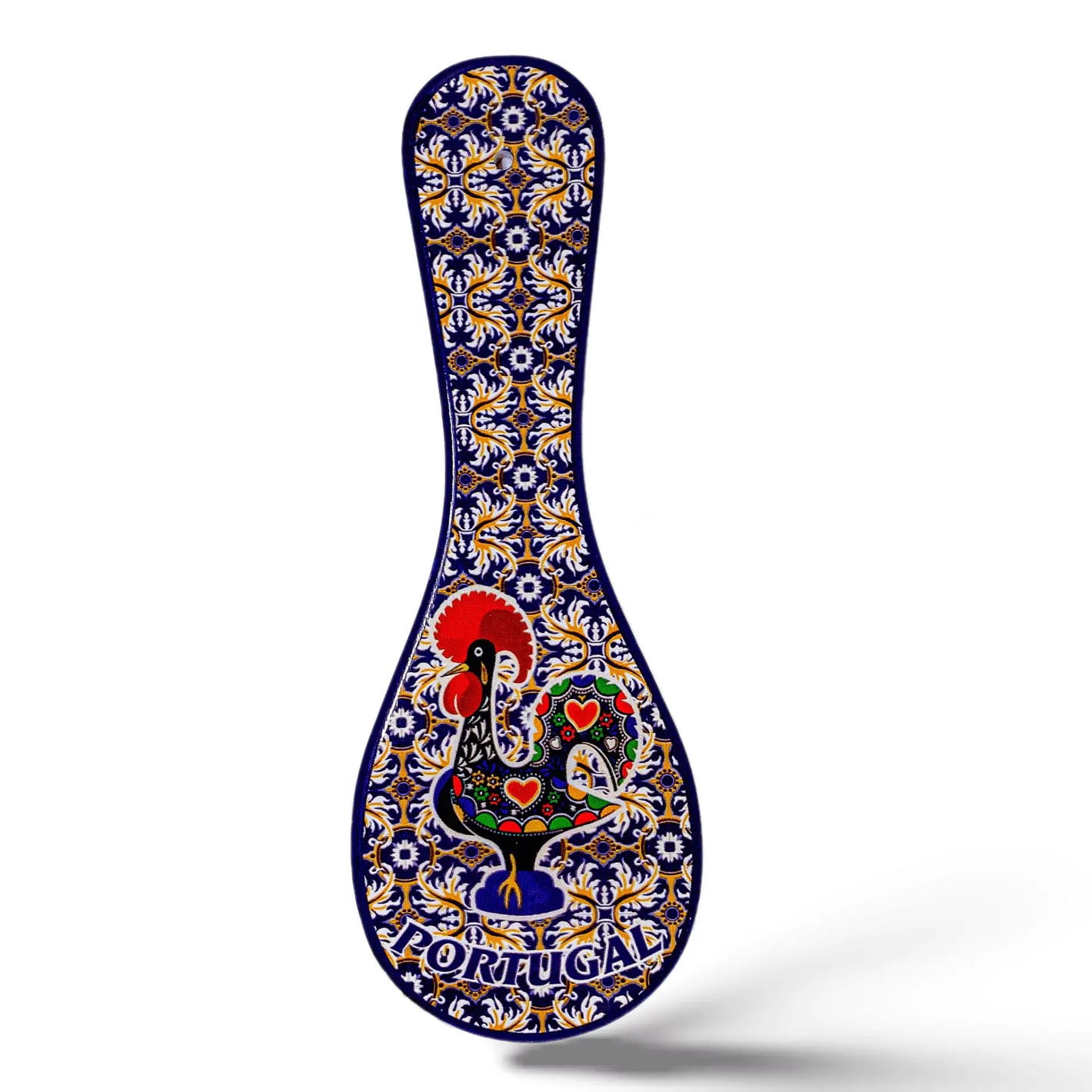 A decorative ceramic spoon-shaped souvenir boasts intricate patterns in blue, yellow, and white. At the center is a vibrant image of the iconic Portuguese rooster, surrounded by floral designs. The word "PORTUGAL" is prominently displayed at the bottom.