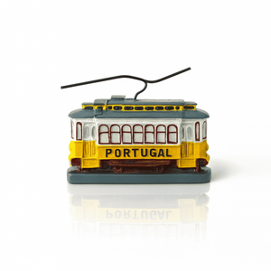 A polyresin miniature of a yellow Lisbon tram with 'PORTUGAL' written on the side, featuring red and white details and a black wire.