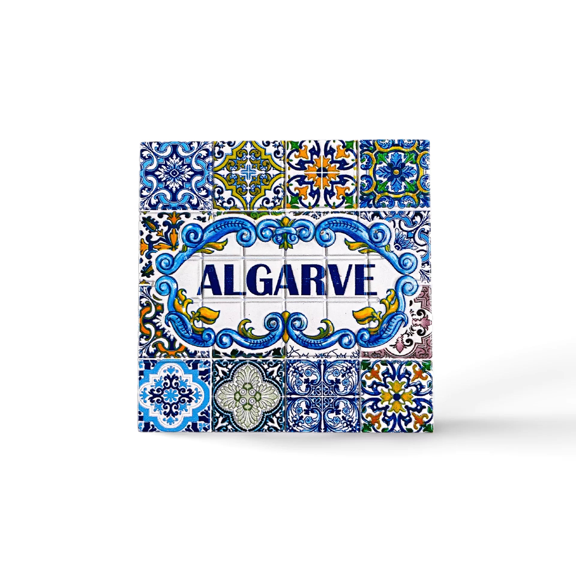 A vibrant ceramic tile magnet with "ALGARVE" boldly in the center. The tile showcases intricate blue, yellow, green, and white patterns and floral motifs, reflecting traditional Portuguese azulejos artwork. A perfect souvenir to capture the essence of Algarve.